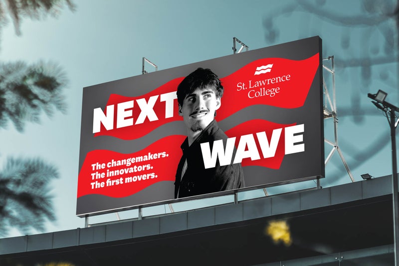 A Next Wave billboard design shown in environmental context.